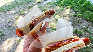 Hand holding swedish hotdog, Â«Â korv med brÃ¶dÂ Â»